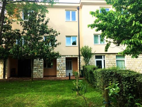 an apartment building with a green yard at Pansion Bencun in Međugorje