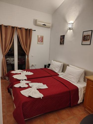 a hotel room with two beds with towels on them at Grandma's Pine Apartments in Skála