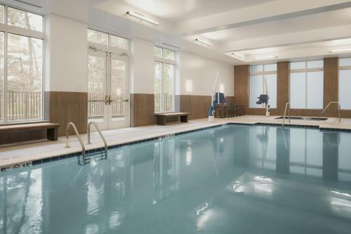 a large swimming pool in a room with windows at AC Hotel Asheville Biltmore Village in Asheville