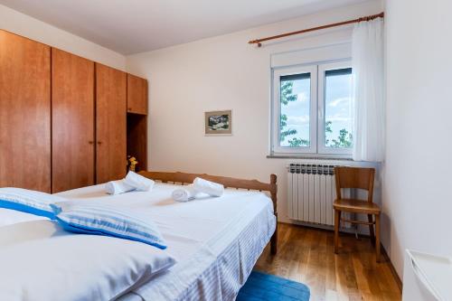 a bedroom with two beds and a window at Beverly Klis House in Klis