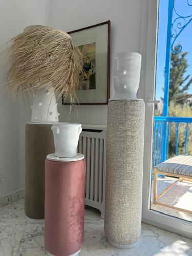 a group of three vases sitting on a table at Olivia sidibou in Sidi Bou Saïd