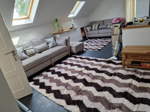 a living room with a couch and a rug at The Flat at Clocktower Buildings in Kinloss