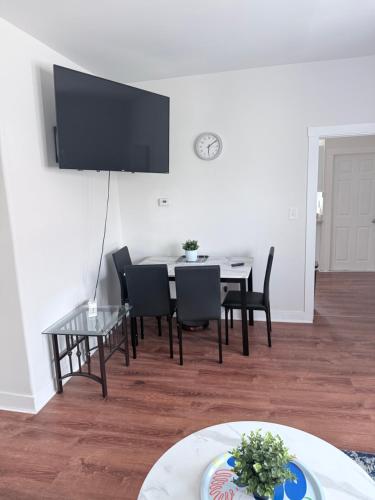 a dining room with a table and chairs and a tv at Quiet private room in Fall River