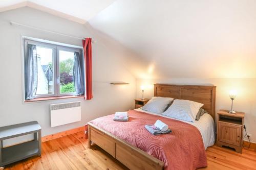 une chambre avec un grand lit et une fenêtre dans l'établissement La Hulotte - Paisibilité et Patrimoine, à Vaux-sur-Aure