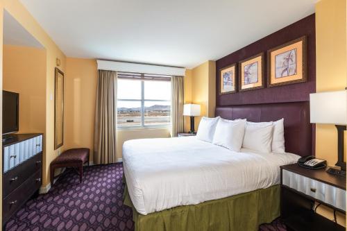 a hotel room with a large bed and a television at The Grandview at Las Vegas in Las Vegas