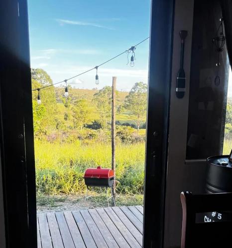 a door to a room with a view of a field at Bangalô Soberano in Brasilia