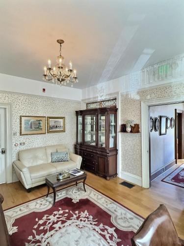 a living room with a couch and a table at Historic Sion Bass Guest House in Fort Wayne