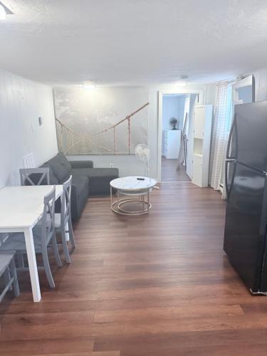 a living room with a couch and a table at Garden level one bedroom apartment in Brockton