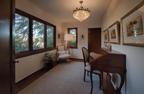 a living room with a piano and a chair at Timeless Elegance-5BR 1930s Home in Sebastopol