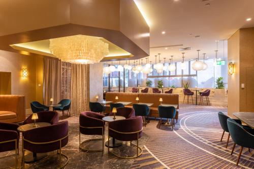 a lobby of a hotel with chairs and tables at Rydges South Bank Brisbane in Brisbane