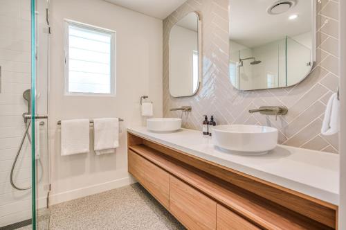 a bathroom with two sinks and a mirror at Essence Peregian Beach in Peregian Beach