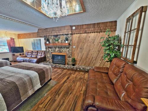 a bedroom with a bed and a fireplace at Cedar Wood Inn in Deadwood