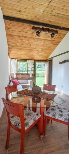 a dining room with a table and two chairs at Confortable cabaña campestre in Ibarra