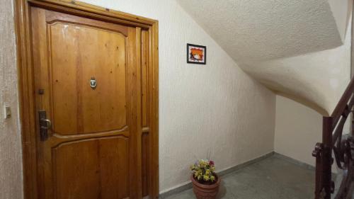 a wooden door in a hallway with a flower pot at Dar sidi in Rabat