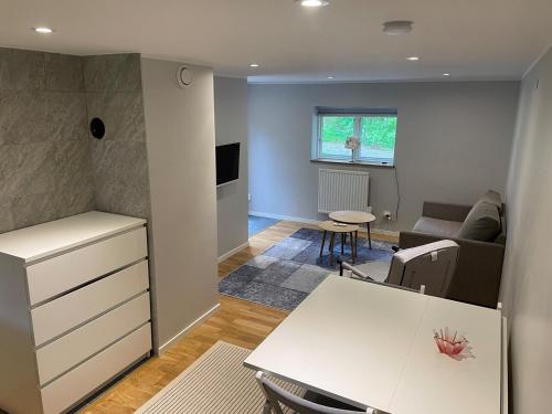 a living room with a couch and a table at Lilla Skogsnära in Kolmården