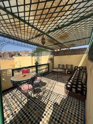 a balcony with a bed and a table and chairs at Le panoramique de Fes in Fès