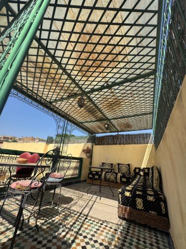 a screened in porch with chairs and a couch at Le panoramique de Fes in Fès