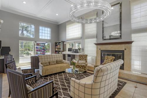 a living room with a fireplace and a chandelier at Best Western Plus Dixon Davis in Dixon