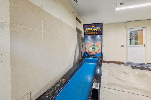 a bowling alley with a game on the wall at CVNP Winter Getaway - 5 mins to Boston Mills Ski in Northfield