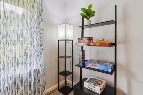 a black book shelf in a room with a curtain at CVNP Winter Getaway - 5 mins to Boston Mills Ski in Northfield