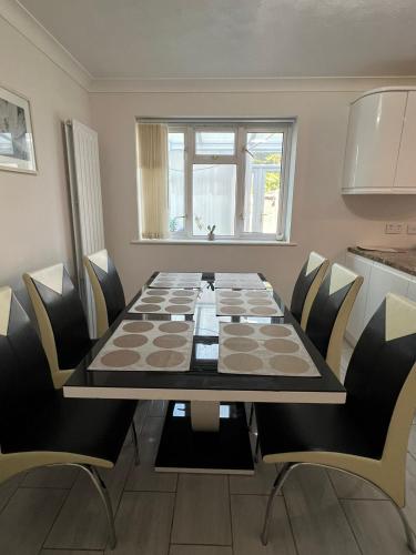 a dining room with a table and chairs at Spacious 4 bed Farnborough AirShow in Farnborough