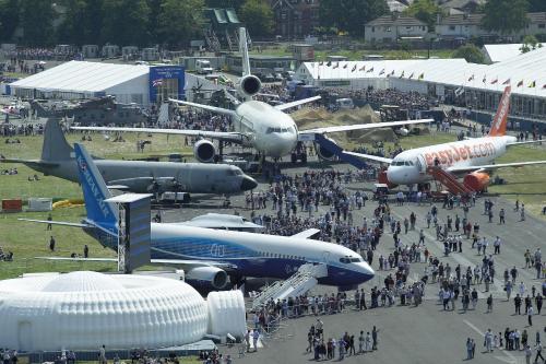 a group of people standing around airplanes in a field at Spacious 4 bed Farnborough AirShow in Farnborough