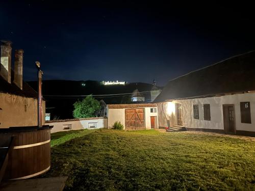 a night view of a house with a yard at Castle View Saschiz - Traditional Guesthouse in Saschiz