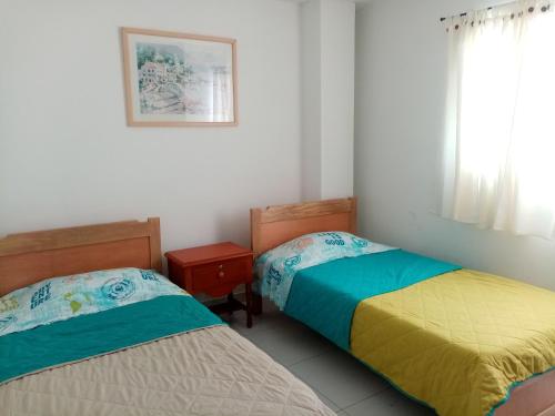 a bedroom with two beds and a window at Apartamento Familiar residencial M2 in Sincelejo