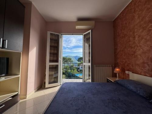a bedroom with a large bed and a large window at Ligo in Villanova dʼAlbenga