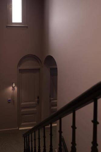 a stairway with a door and a window at Hotel Blue Inspired by Manna in Nijmegen
