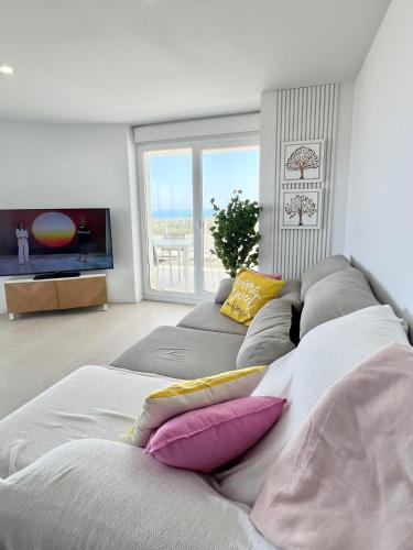 a living room with a couch with pillows on it at Luxury Canet in Canet de Berenguer