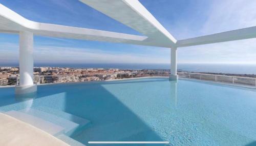 a swimming pool with a view of the city at Luxury Canet in Canet de Berenguer