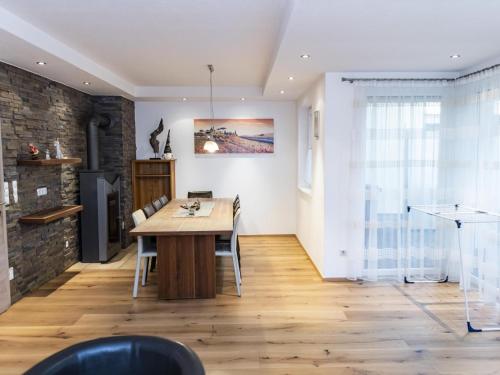 a dining room with a wooden table and chairs at Ferienhaus Gartentraum 1 in Itter