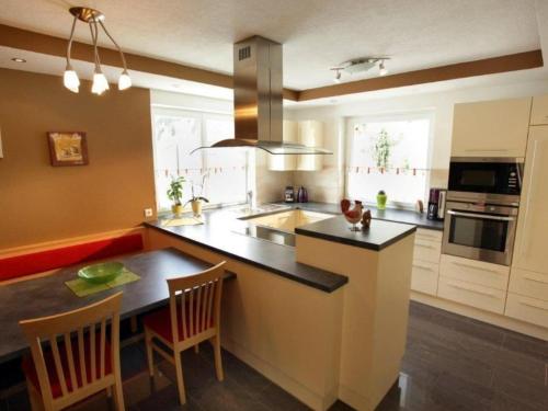 a kitchen with a large island with a counter top at Ferienhaus Gartentraum 1 in Itter