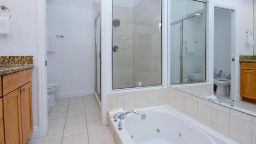 a bathroom with a tub and a shower and a toilet at 409 Mariners Club in Key Largo