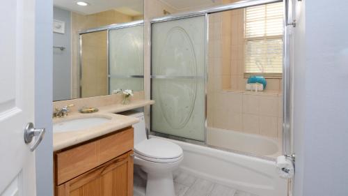 a bathroom with a toilet and a shower and a sink at 409 Mariners Club in Key Largo