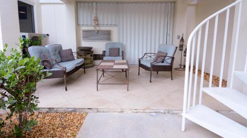 a patio with chairs and a table and stairs at 409 Mariners Club in Key Largo
