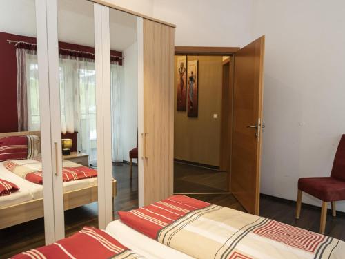 a bedroom with two beds and a mirror at Ferienhaus Gartentraum 1 in Itter