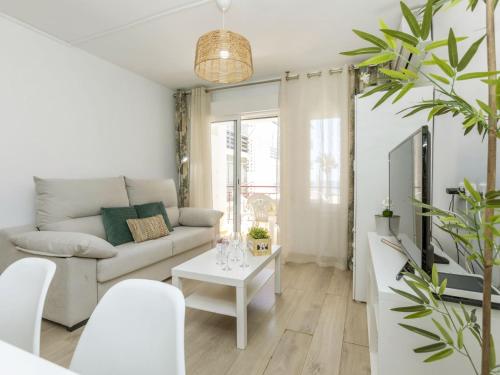 a living room with a couch and a table at Apartment Oasis Cambrils by Interhome in Cambrils