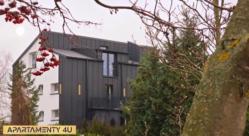 a black house with a white at Willa 4U in Rumia