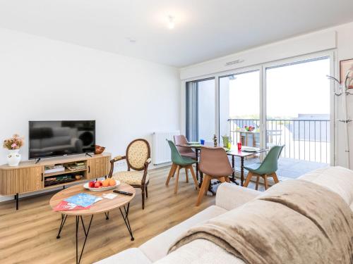 a living room with a couch and a table at Apartment Colette by Interhome in Saint-Coulomb