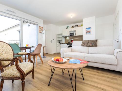a living room with a couch and a table at Apartment Colette by Interhome in Saint-Coulomb
