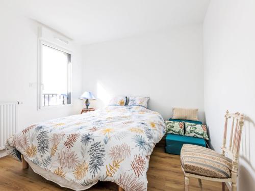a bedroom with a bed with a colorful comforter at Apartment Colette by Interhome in Saint-Coulomb