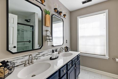 a bathroom with two sinks and a large mirror at Private Room in Ballantyne in Charlotte