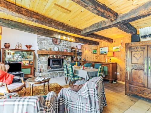 a living room with wooden ceilings and a stone fireplace at Holiday Home Ty-2-Go by Interhome in Trégunc