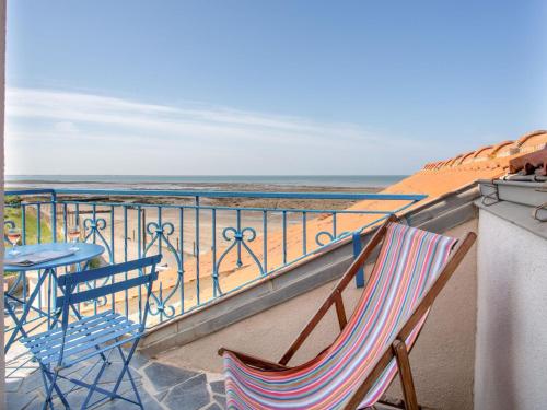 a balcony with two chairs and a table and the ocean at Holiday Home Ker Lann by Interhome in La Bernerie-en-Retz