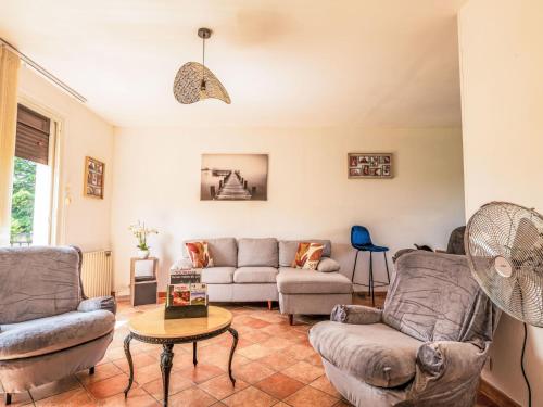 a living room with two couches and a table at Holiday Home Maison du Pountet by Interhome in Lacapelle-Biron
