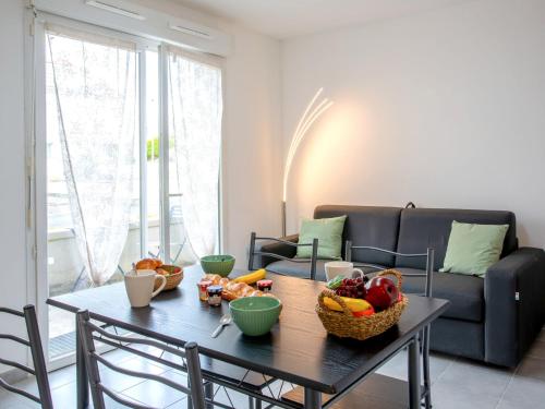 a table with fruit on it in a living room at Studio Résidence de la Source by Interhome in Prigny