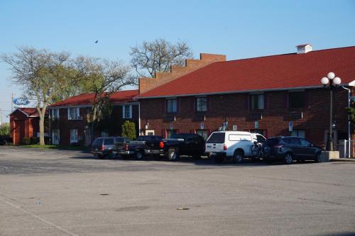 a group of cars parked in front of a brick building at Bellevue Hotel and Suites in Bellevue