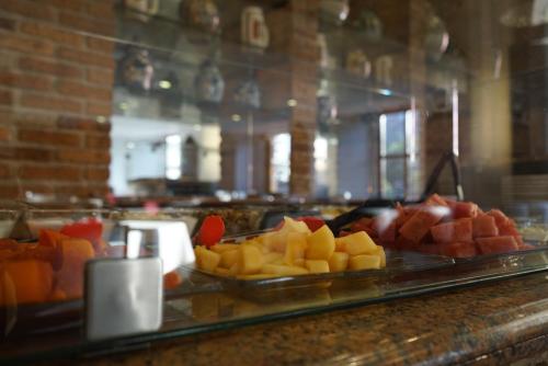 a buffet of fruit on a counter in a restaurant at Hotel Santiago De Compostela - Guadalajara Centro Historico in Guadalajara